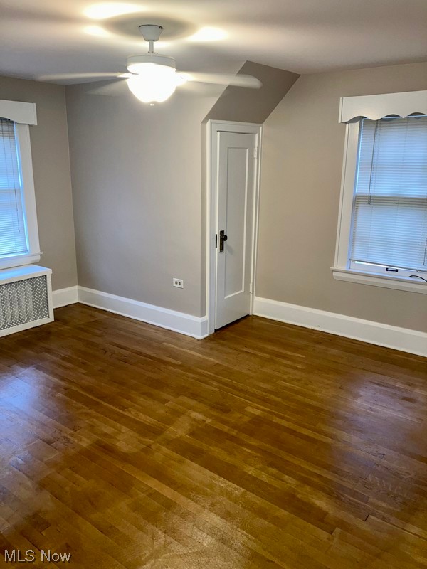 2108 Volney Road Youngstown, OH 44511 - Photo 16 of 27 Unfurnished room with ceiling fan, dark hardwood / wood-style flooring, and radiator heating unit