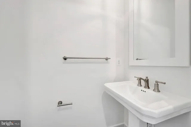 a bathroom with a sink and mirror