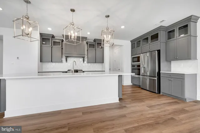 a view of kitchen with refrigerator microwave and stove