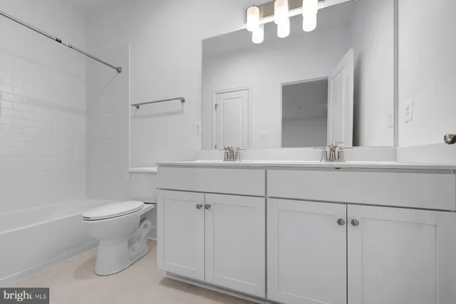 a bathroom with a sink vanity and toilet