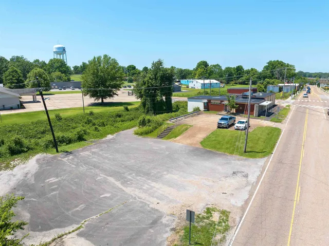 an aerial view of residential houses with outdoor space and street view