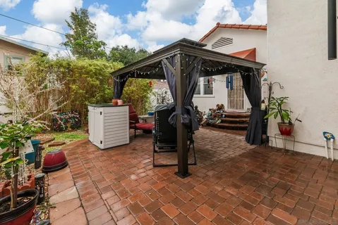 a view of backyard with a table and chairs