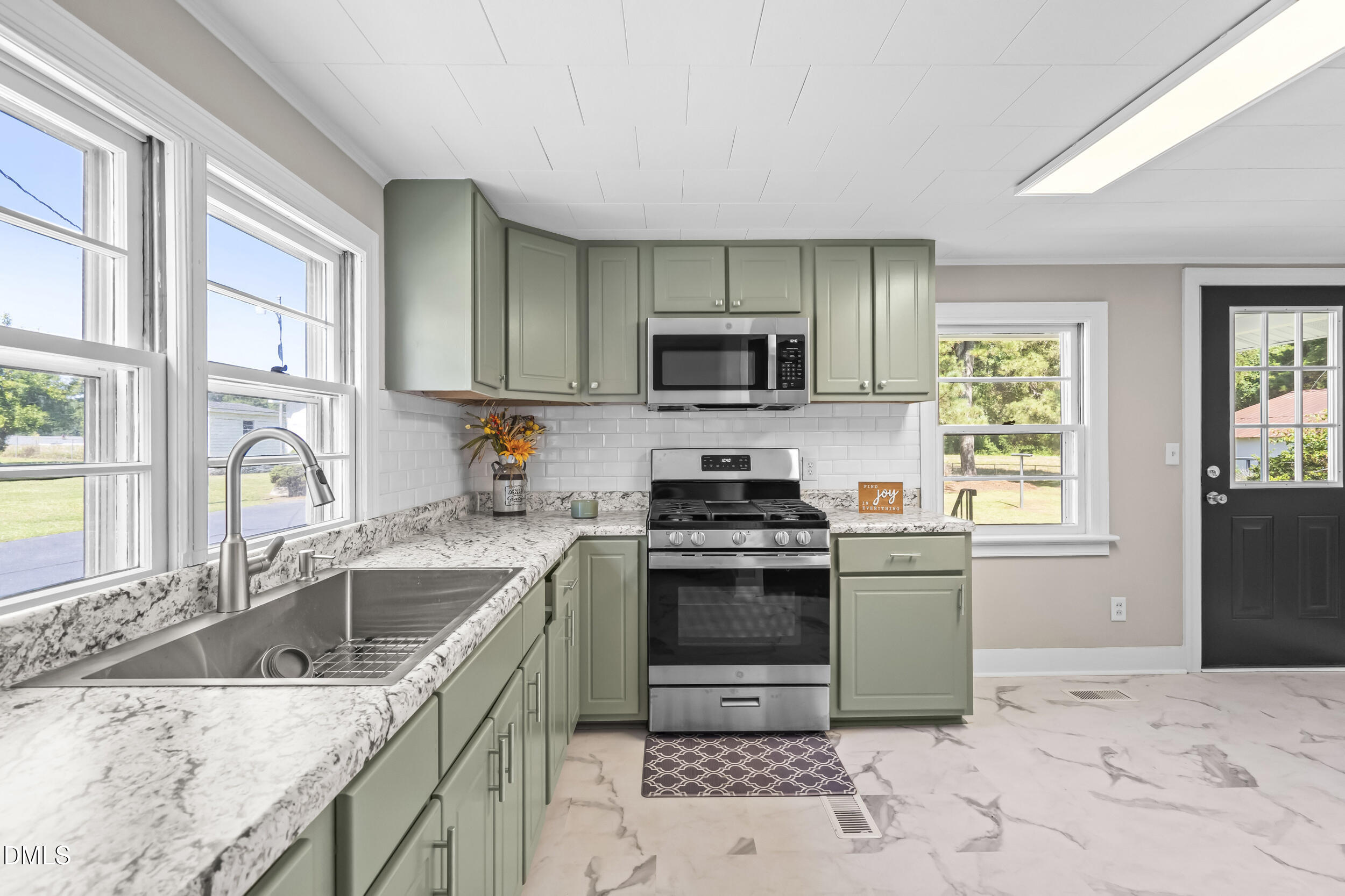 5511 Flower Hill Road Kenly, NC 27542 - Photo 20 of 33 a kitchen with a sink stove top oven and refrigerator