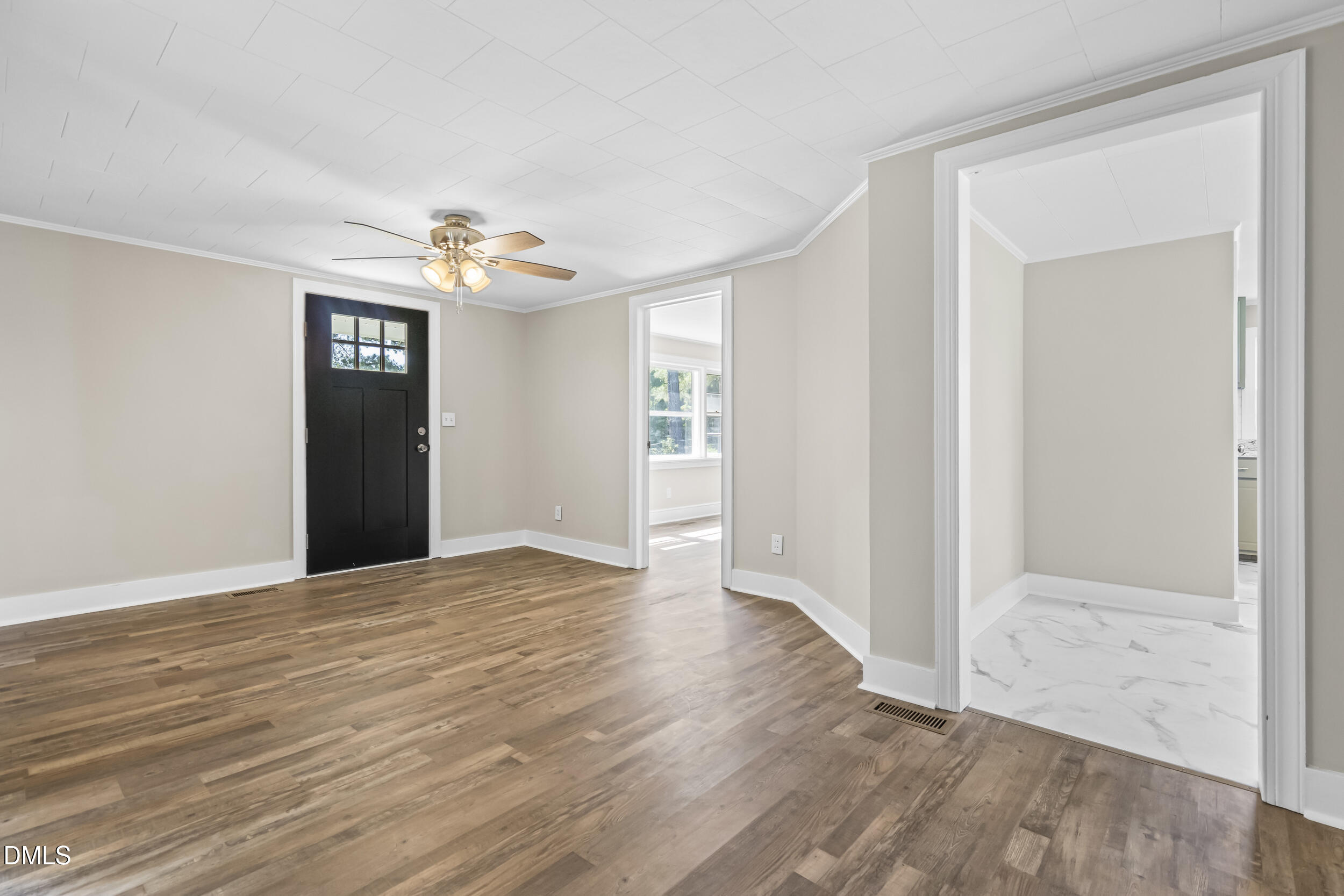 5511 Flower Hill Road Kenly, NC 27542 - Photo 8 of 33 a view of an empty room with wooden floor and a window
