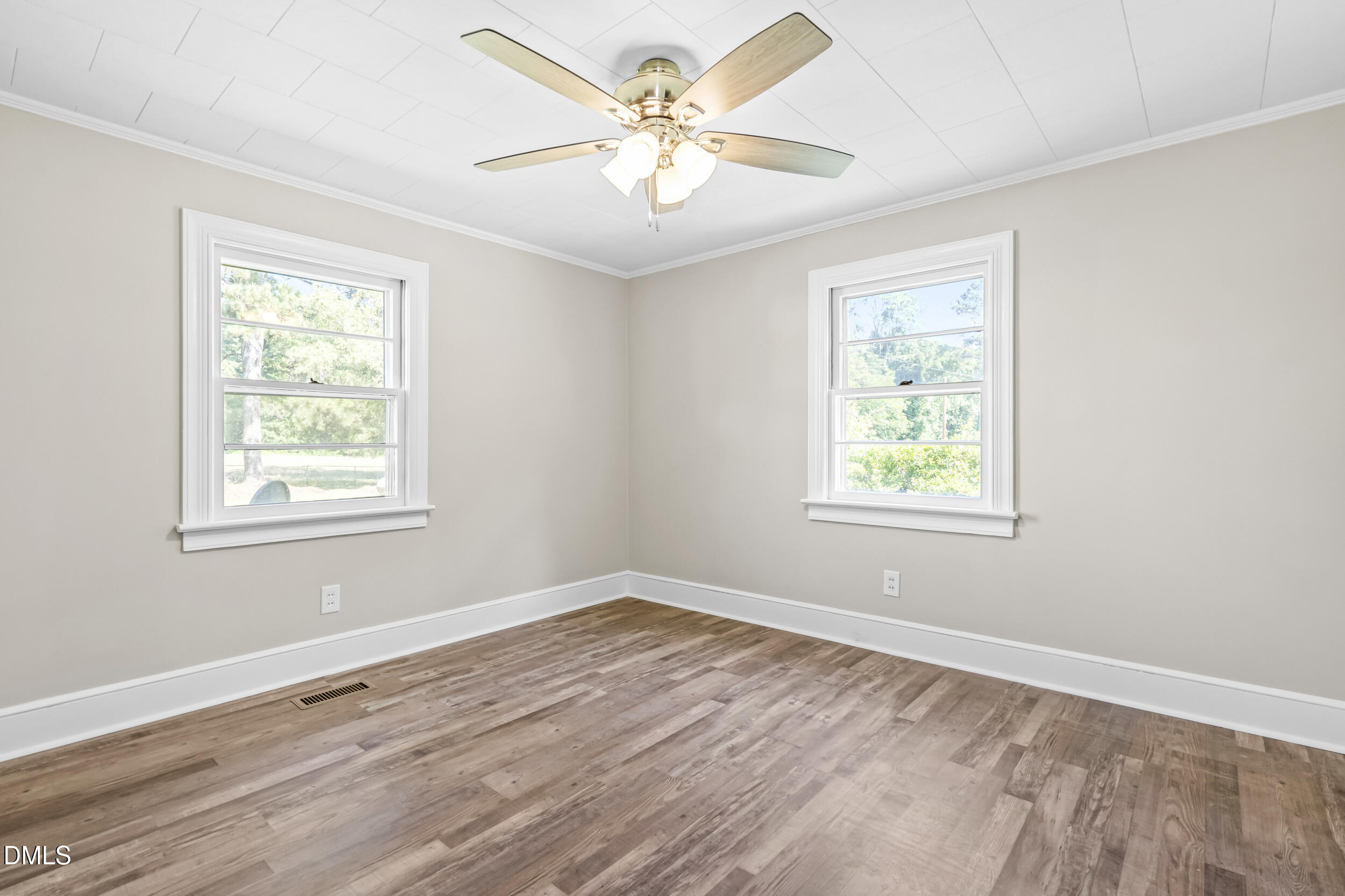 5511 Flower Hill Road Kenly, NC 27542 - Photo 9 of 33 an empty room with wooden floor and windows
