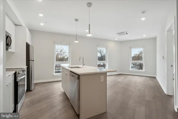 a kitchen with a sink appliances and cabinets