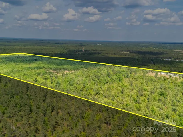 a view of a green field with an outdoor space