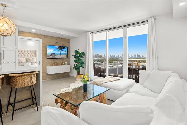 a living room with furniture and a floor to ceiling window