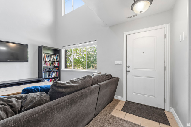 1165 West 100 South Springville, UT 84663 - Photo 4 of 28 Living room featuring plenty of natural light, light tile patterned flooring, and a high ceiling