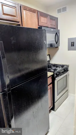 a kitchen with granite countertop a sink a stove and cabinets