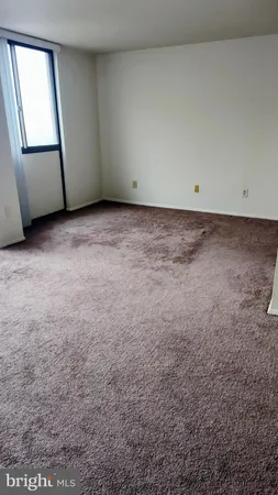 an empty room with wooden floor and cabinet