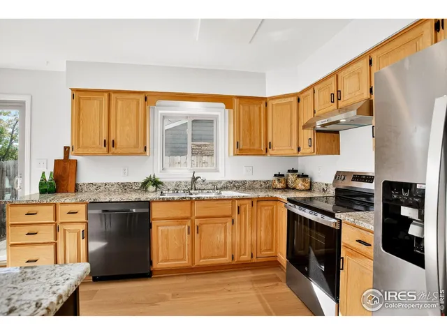 a kitchen with stainless steel appliances granite countertop a stove a sink dishwasher and a refrigerator