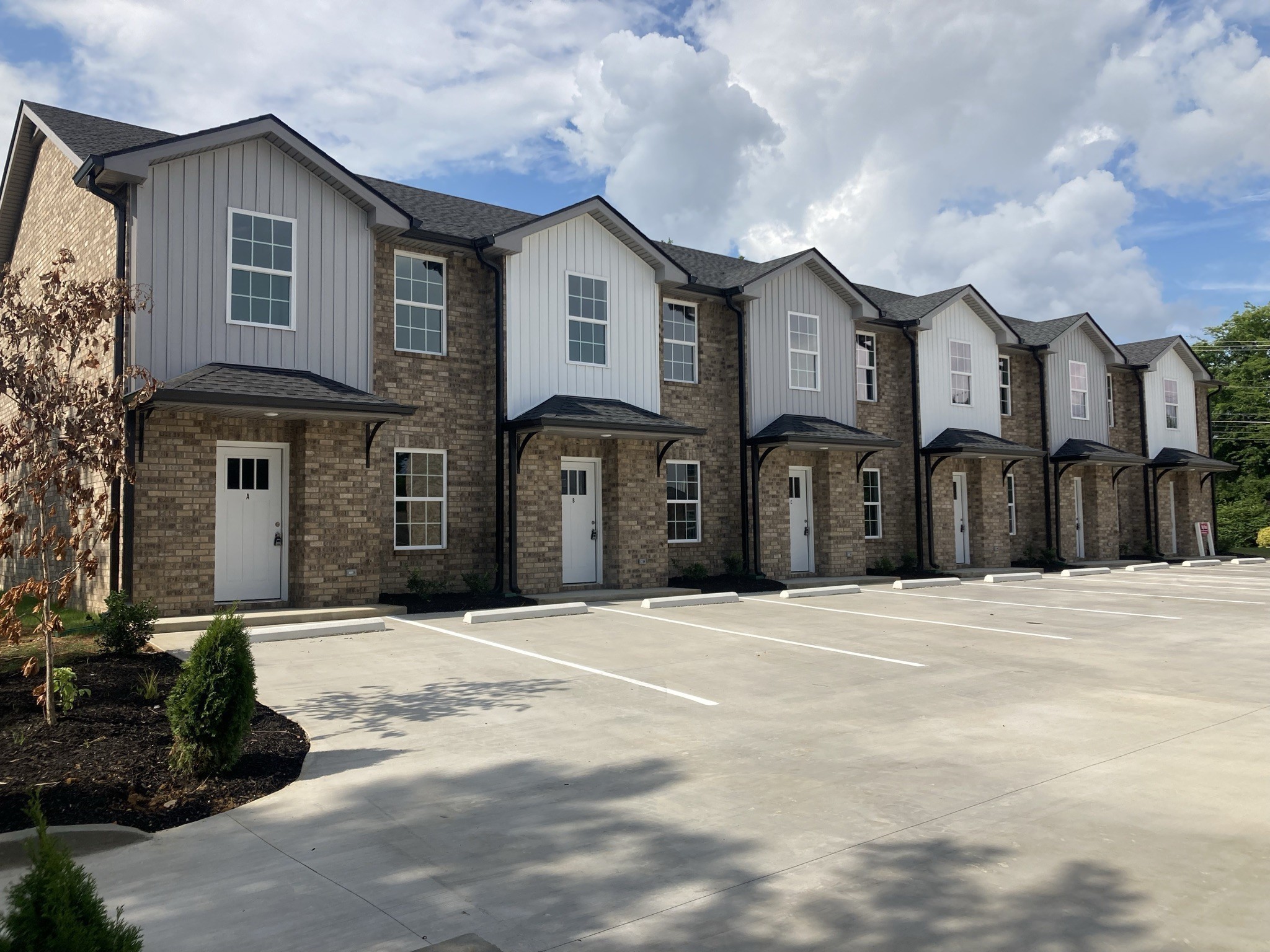 914 Peachers Mill Road, Unit E Clarksville, TN 37042 - Photo 2 of 30 a front view of a house with a yard and garage