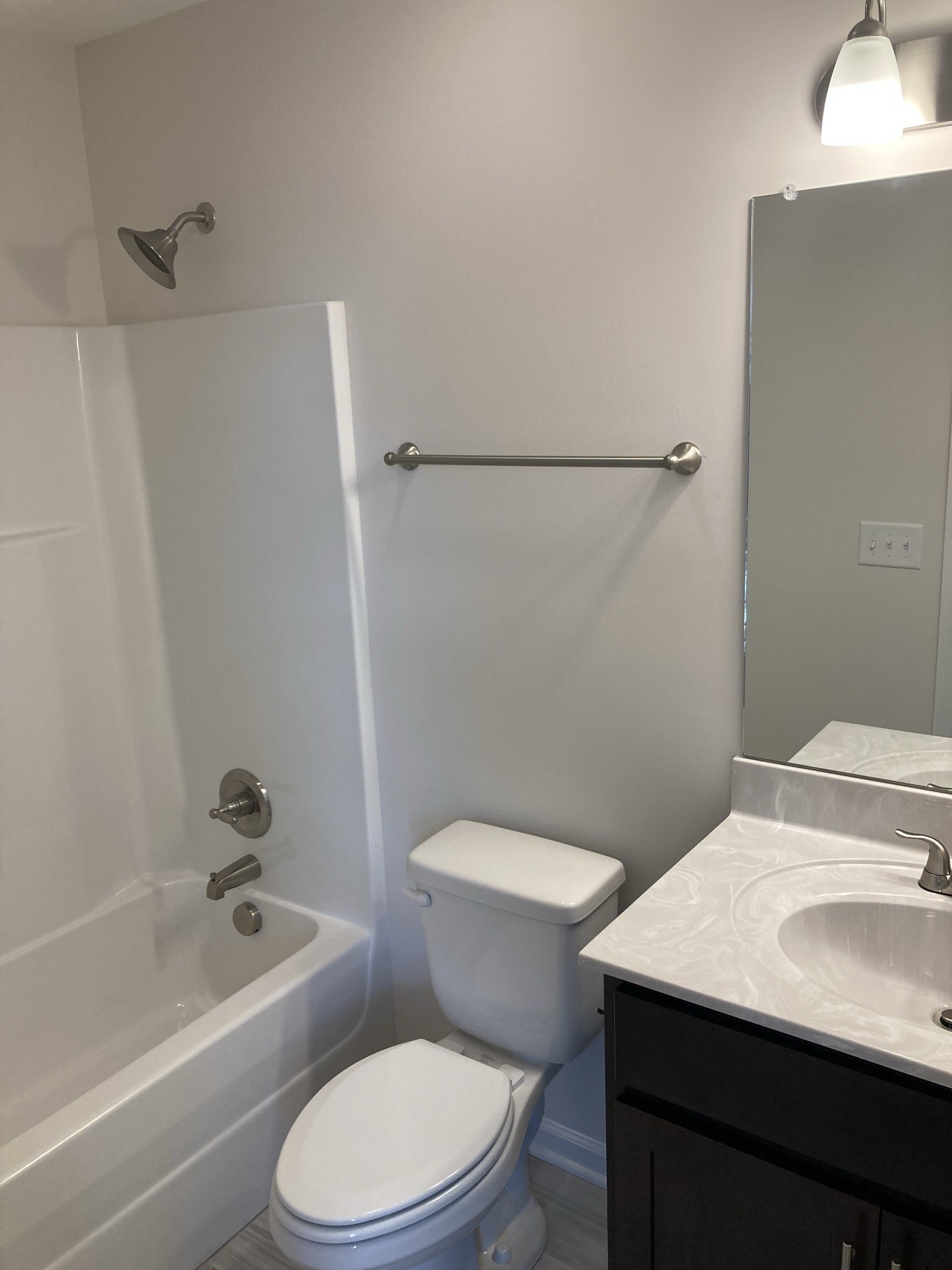 914 Peachers Mill Road, Unit E Clarksville, TN 37042 - Photo 21 of 30 a white toilet sitting next to a bath tub