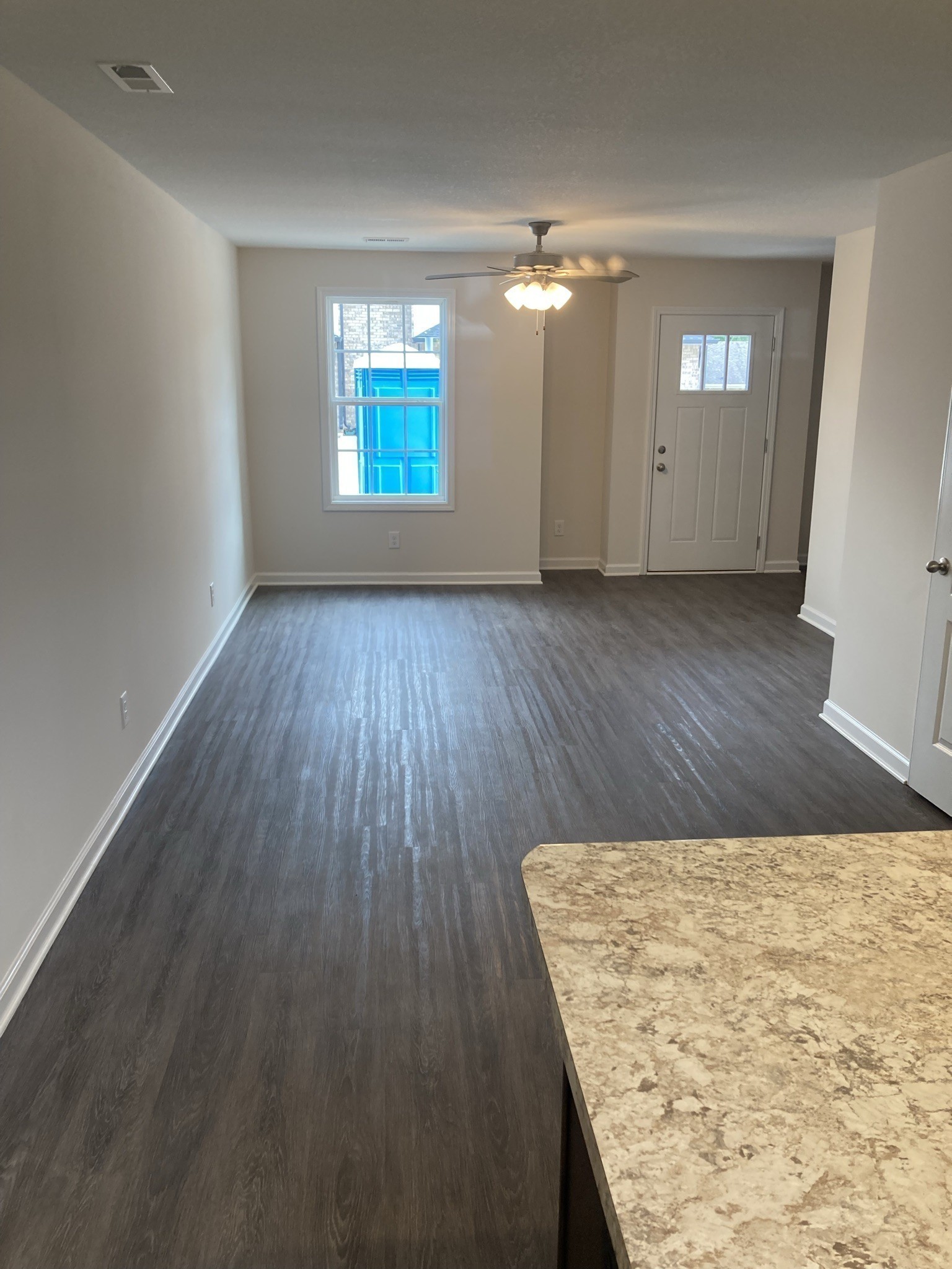 914 Peachers Mill Road, Unit E Clarksville, TN 37042 - Photo 6 of 30 wooden floor in an empty room with a kitchen