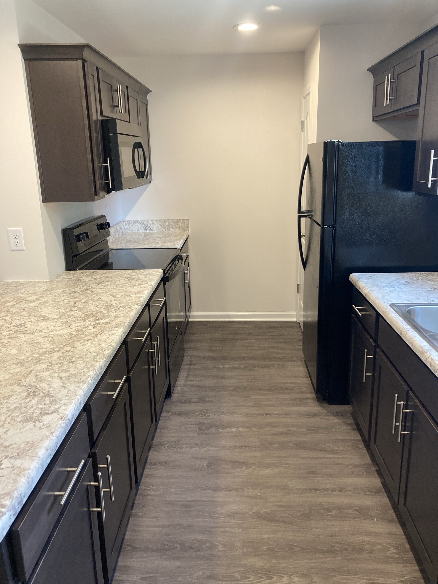 914 Peachers Mill Road, Unit E Clarksville, TN 37042 - Photo 7 of 30 a kitchen with stainless steel appliances granite countertop a sink stove and refrigerator