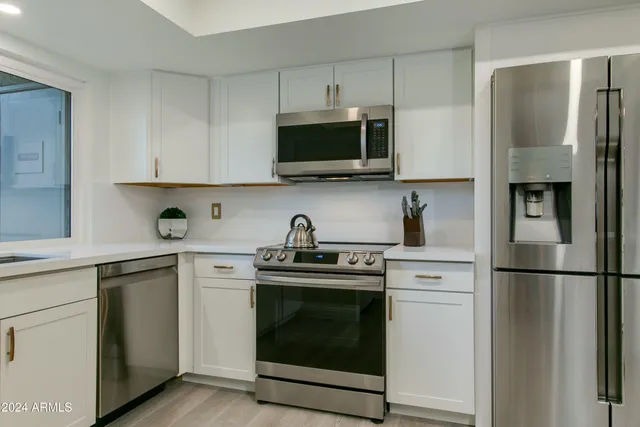 a kitchen with a refrigerator and a sink