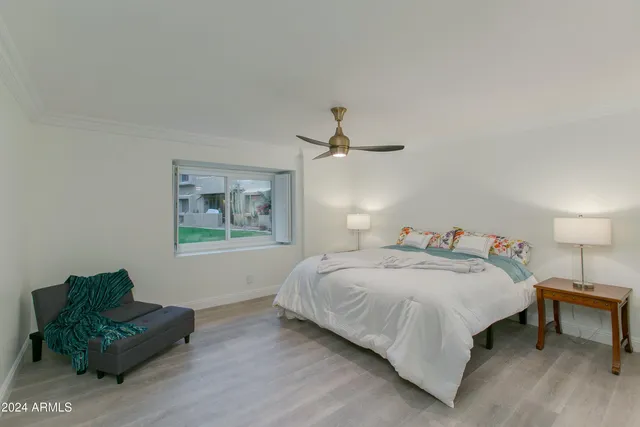 a bedroom with a bed and a chandelier