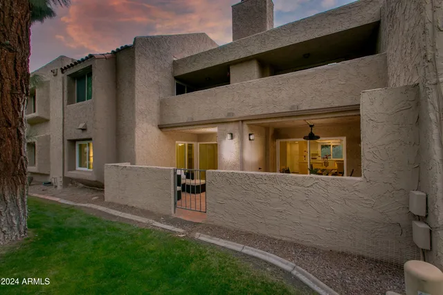 a view of a livingroom with furniture and floor to ceiling window