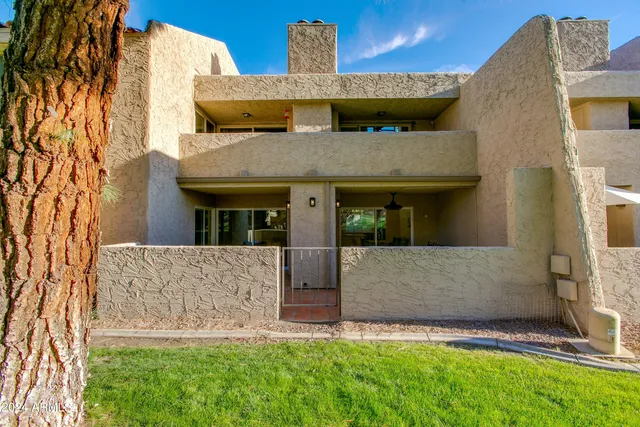 a view of a living room with furniture and floor to ceiling window