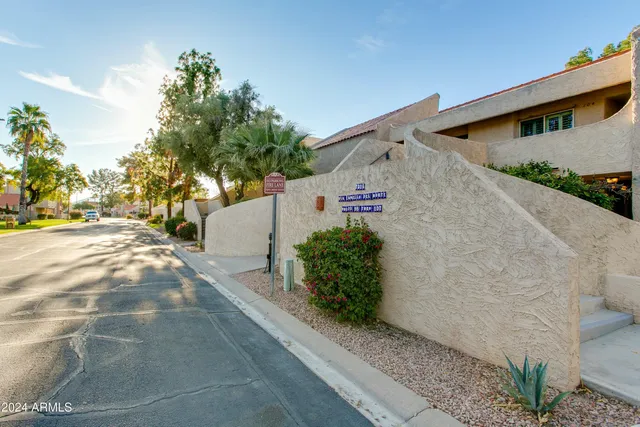 a front view of a house with lots of potted plants