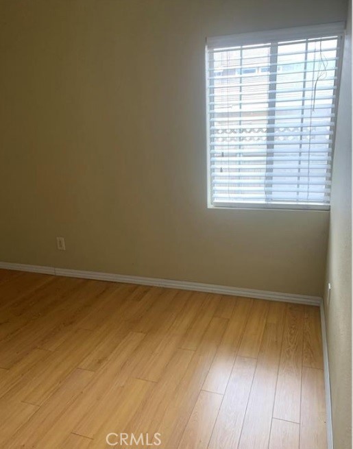 12 Whitecloud Irvine, CA 92614 - Photo 4 of 9 a view of an empty room with wooden floor and a window