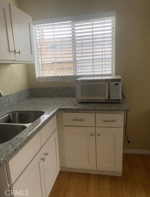 12 Whitecloud Irvine, CA 92614 - Photo 5 of 9 a kitchen with granite countertop white cabinets and a window