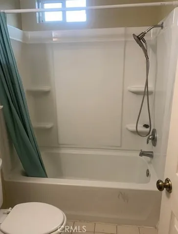 a bathroom with a toilet and a bathtub