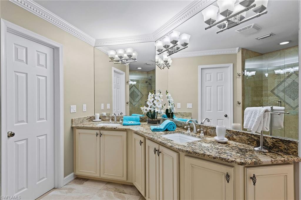 9101 Vanderbilt Drive, Unit 301 Naples, FL 34108 - Photo 12 of 28 a bathroom with a sink double vanity and a mirror