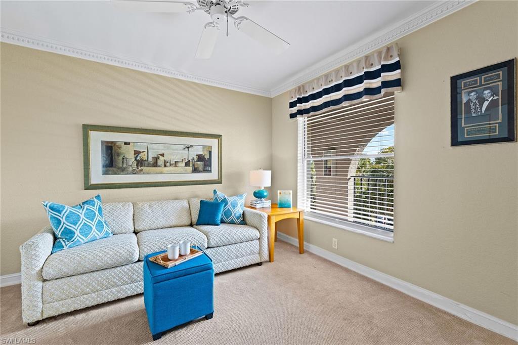 9101 Vanderbilt Drive, Unit 301 Naples, FL 34108 - Photo 14 of 28 a living room with furniture and a window