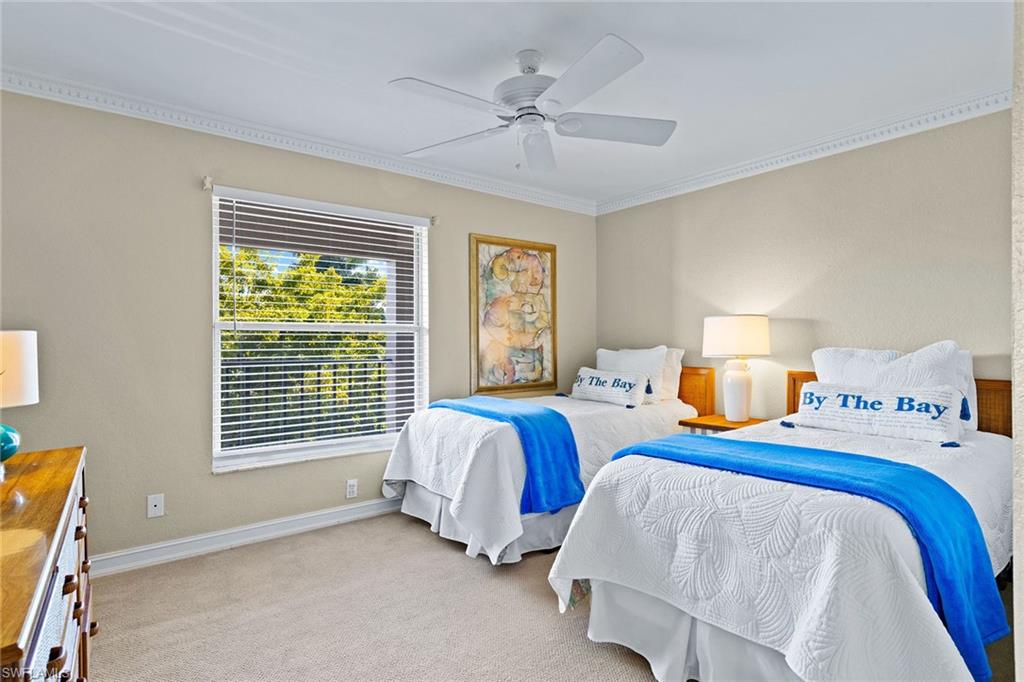 9101 Vanderbilt Drive, Unit 301 Naples, FL 34108 - Photo 15 of 28 a bedroom with two beds and windows