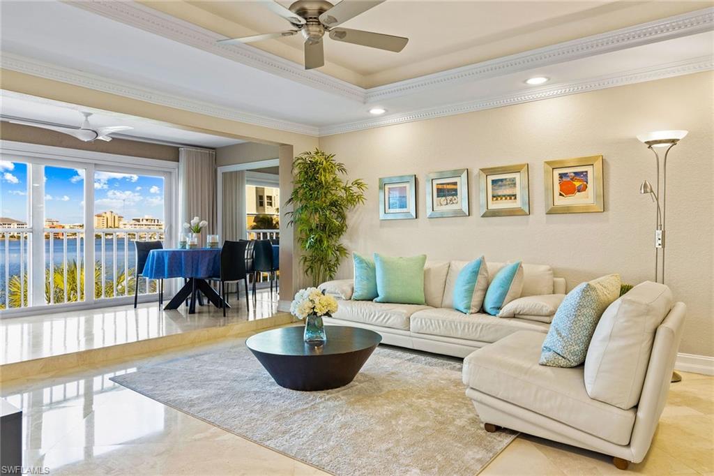 9101 Vanderbilt Drive, Unit 301 Naples, FL 34108 - Photo 2 of 28 a living room with furniture and a potted plant