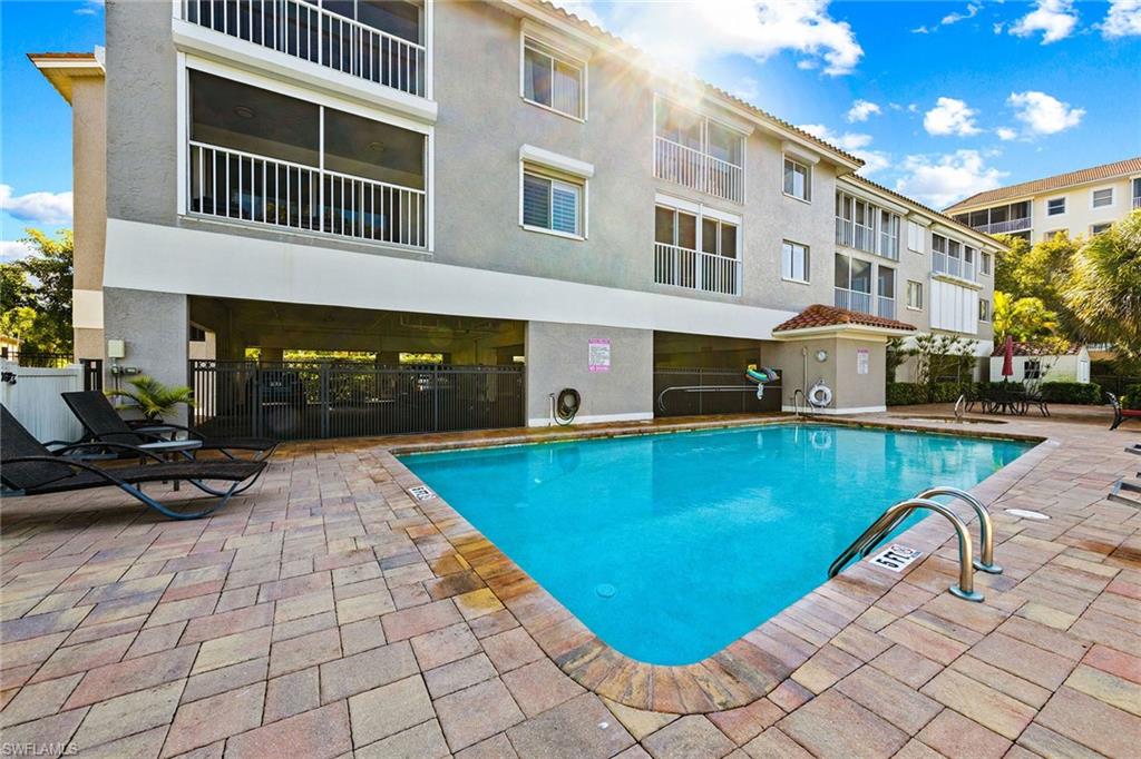 9101 Vanderbilt Drive, Unit 301 Naples, FL 34108 - Photo 21 of 28 a view of swimming pool with outdoor seating
