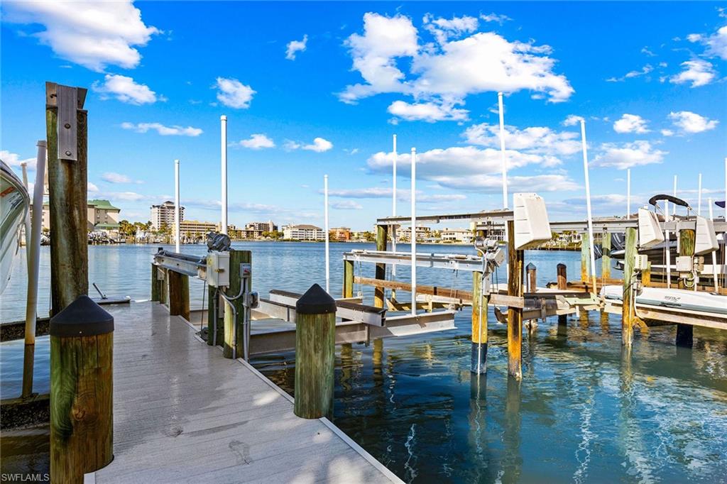 9101 Vanderbilt Drive, Unit 301 Naples, FL 34108 - Photo 23 of 28 a view of a swimming pool and outdoor seating