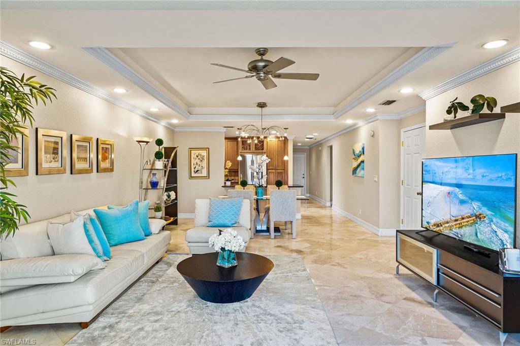 9101 Vanderbilt Drive, Unit 301 Naples, FL 34108 - Photo 4 of 28 a living room with furniture and a wooden floor