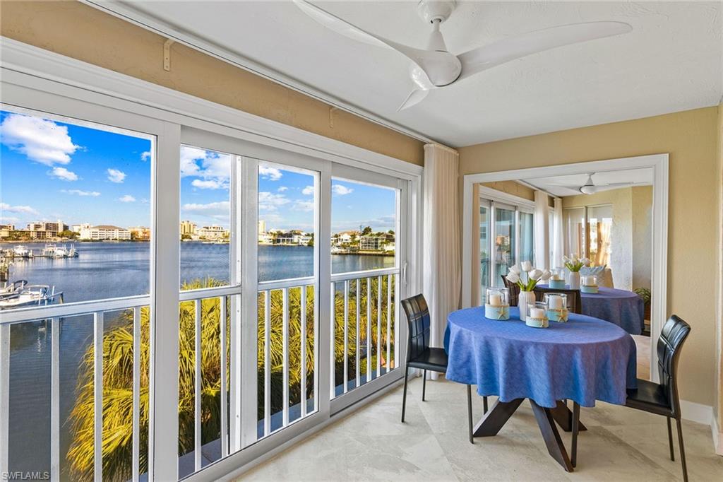 9101 Vanderbilt Drive, Unit 301 Naples, FL 34108 - Photo 9 of 28 a view of a dining room with furniture window and outside view