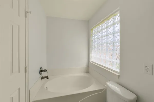 a white bath tub sitting next to a window