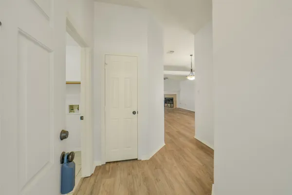 a view of hallway with wooden floor