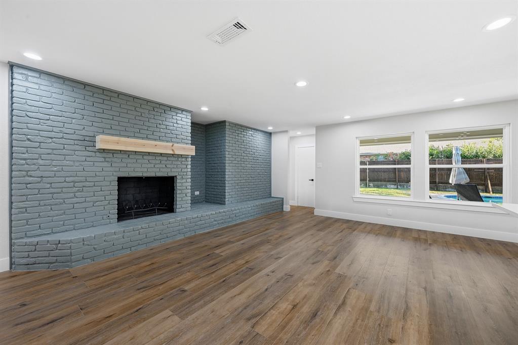1145 Terrace Trail Hurst, TX 76053 - Photo 11 of 36 a view of empty room with wooden floor and fireplace