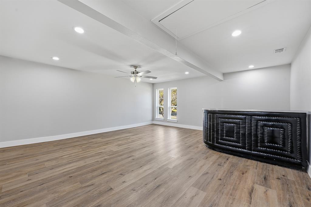 1145 Terrace Trail Hurst, TX 76053 - Photo 14 of 36 a view of an empty room with wooden floor and a window