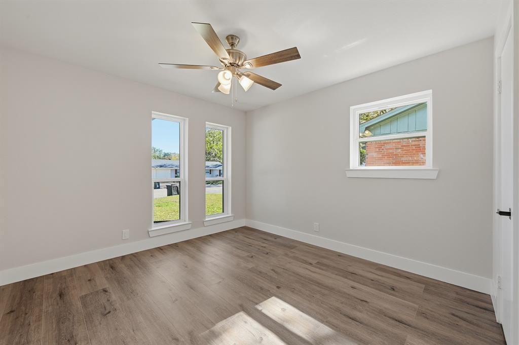 1145 Terrace Trail Hurst, TX 76053 - Photo 22 of 36 a view of an empty room with wooden floor and a window