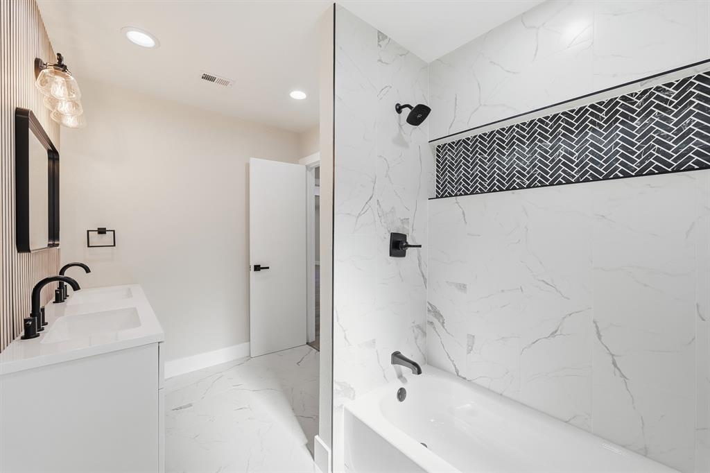 1145 Terrace Trail Hurst, TX 76053 - Photo 23 of 36 a bathroom with a bathtub and a sink