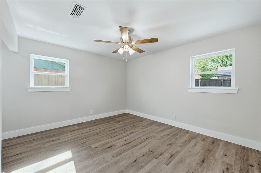 1145 Terrace Trail Hurst, TX 76053 - Photo 25 of 36 a view of a room with wooden floor and a ceiling fan