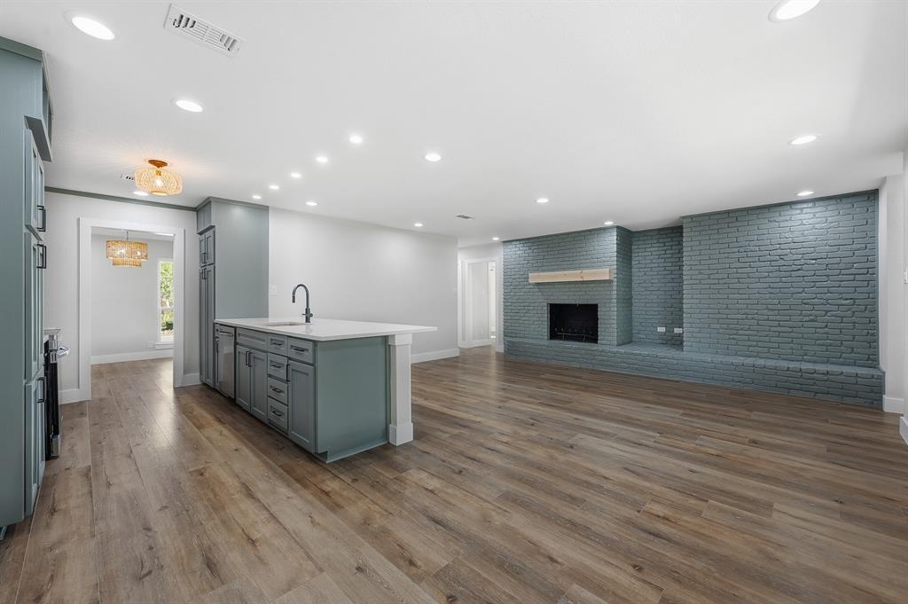 1145 Terrace Trail Hurst, TX 76053 - Photo 5 of 36 a living room with hard wood floors and a kitchen