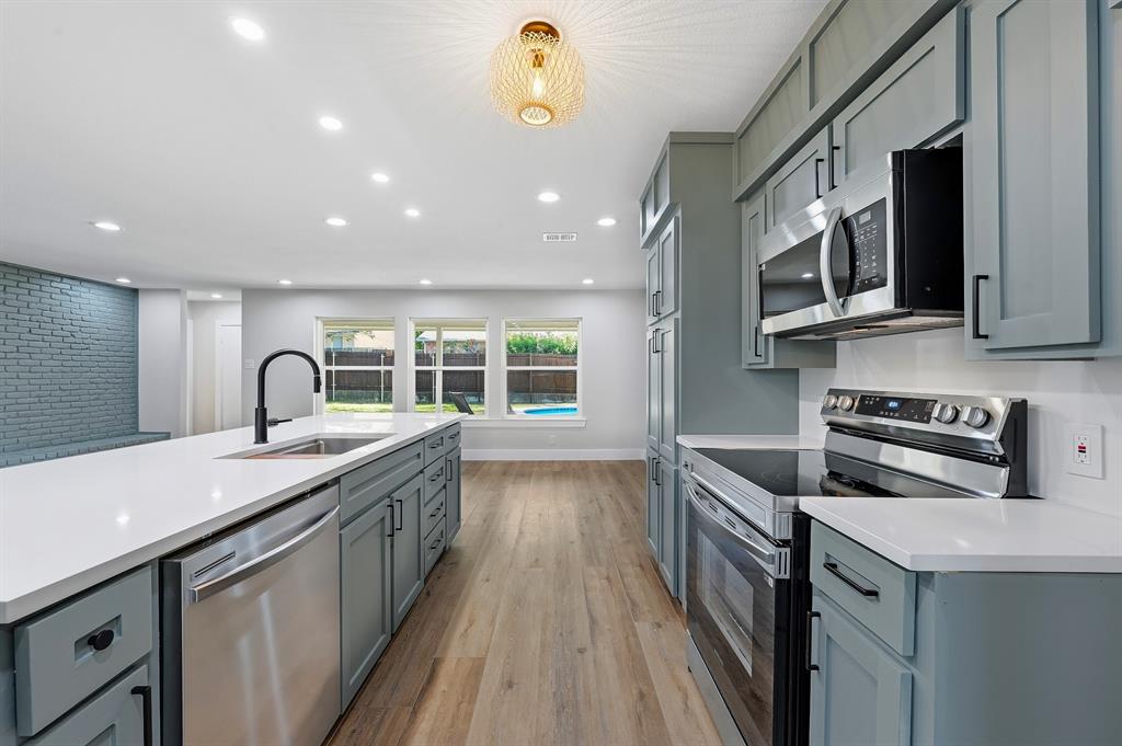 1145 Terrace Trail Hurst, TX 76053 - Photo 8 of 36 a kitchen with stainless steel appliances granite countertop a sink and a microwave