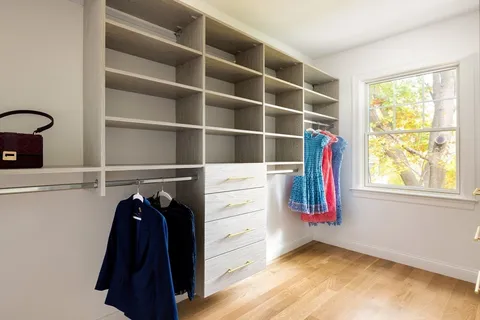 a view of walk in closet with empty racks