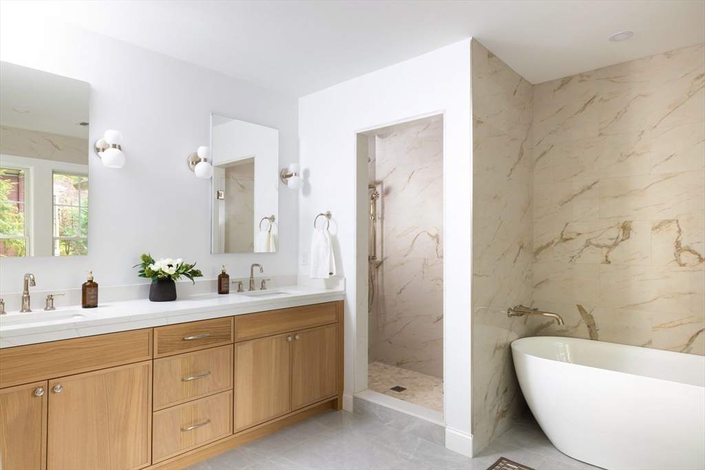 85 Naples Road, Unit 2 Brookline, MA 02446 - Photo 12 of 28 a bathroom with a double vanity sink toilet mirror and bathtub