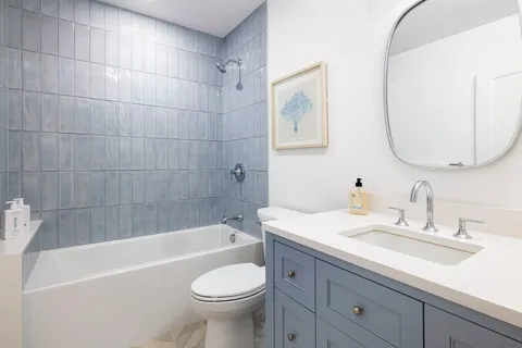 a bathroom with a sink a toilet and bathtub
