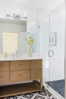 a bathroom with a sink a vanity and window