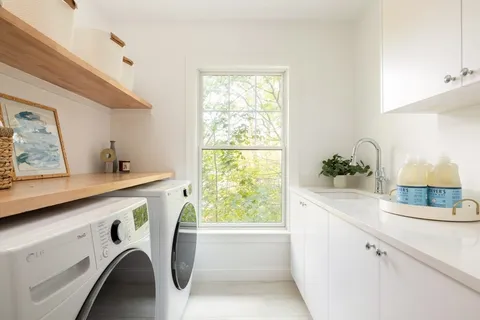 a utility room with cabinets washer and dryer
